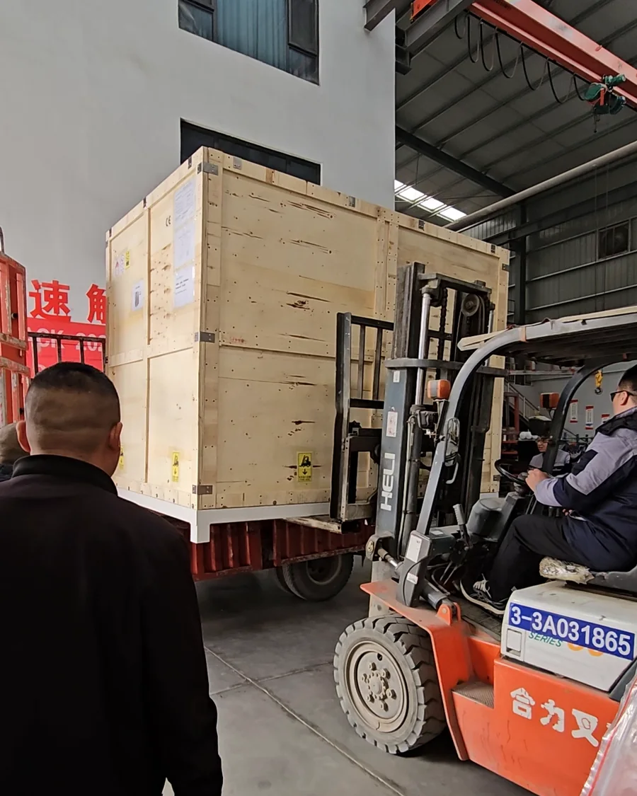 A crated machine being loaded for shipping