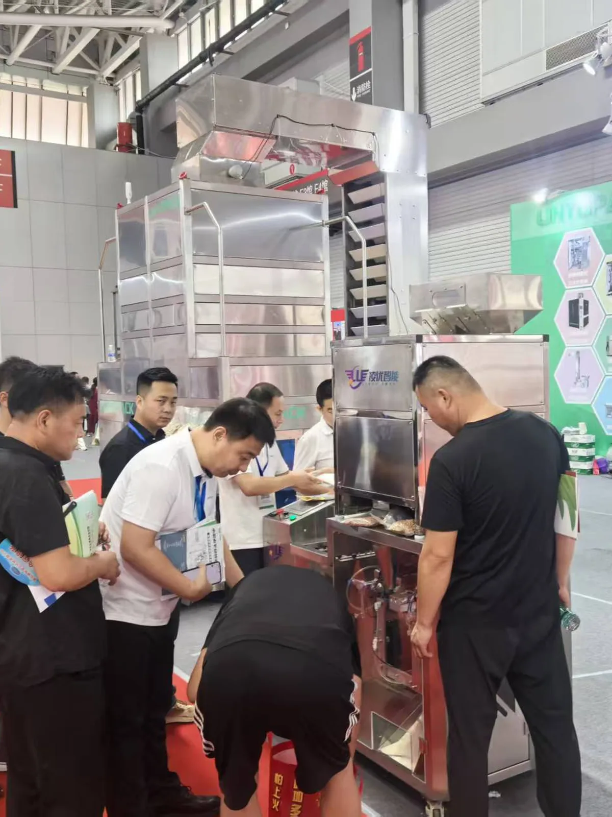 Visitors looking at a VP Series bagger at our stand