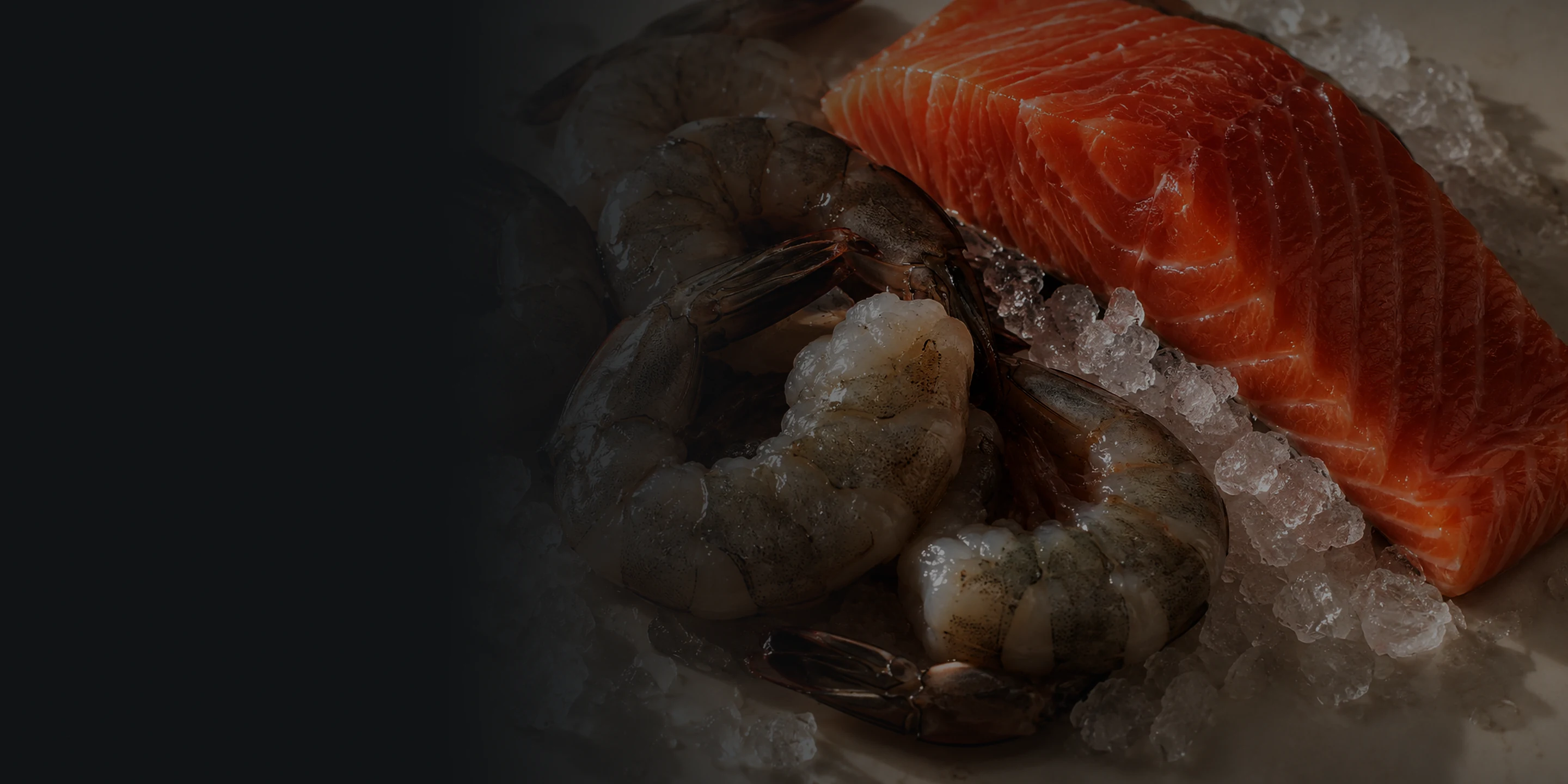 Fresh salmon and prawns on ice