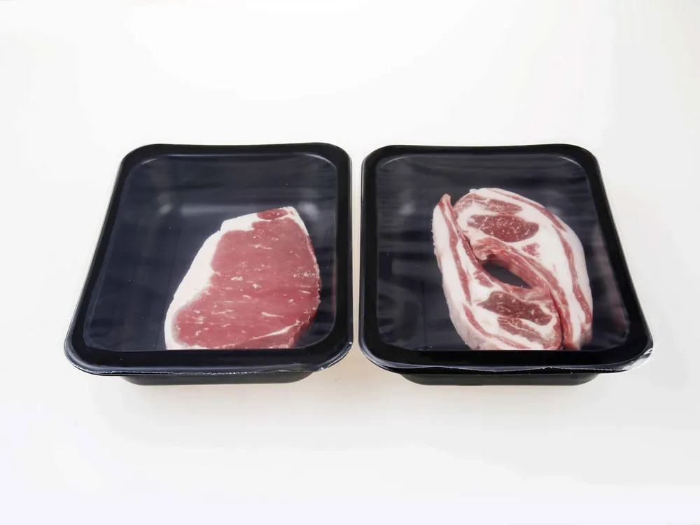 Fresh meat in sealed black trays