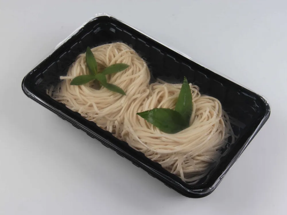 Noodles in a sealed black tray
